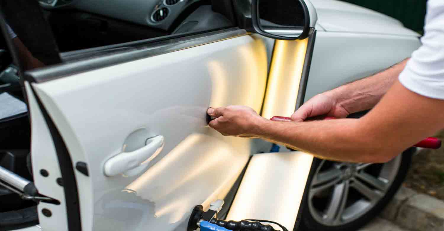 Pulling dent from car door.