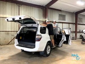 Paintless Dent Repair Technicians Repairing SUV