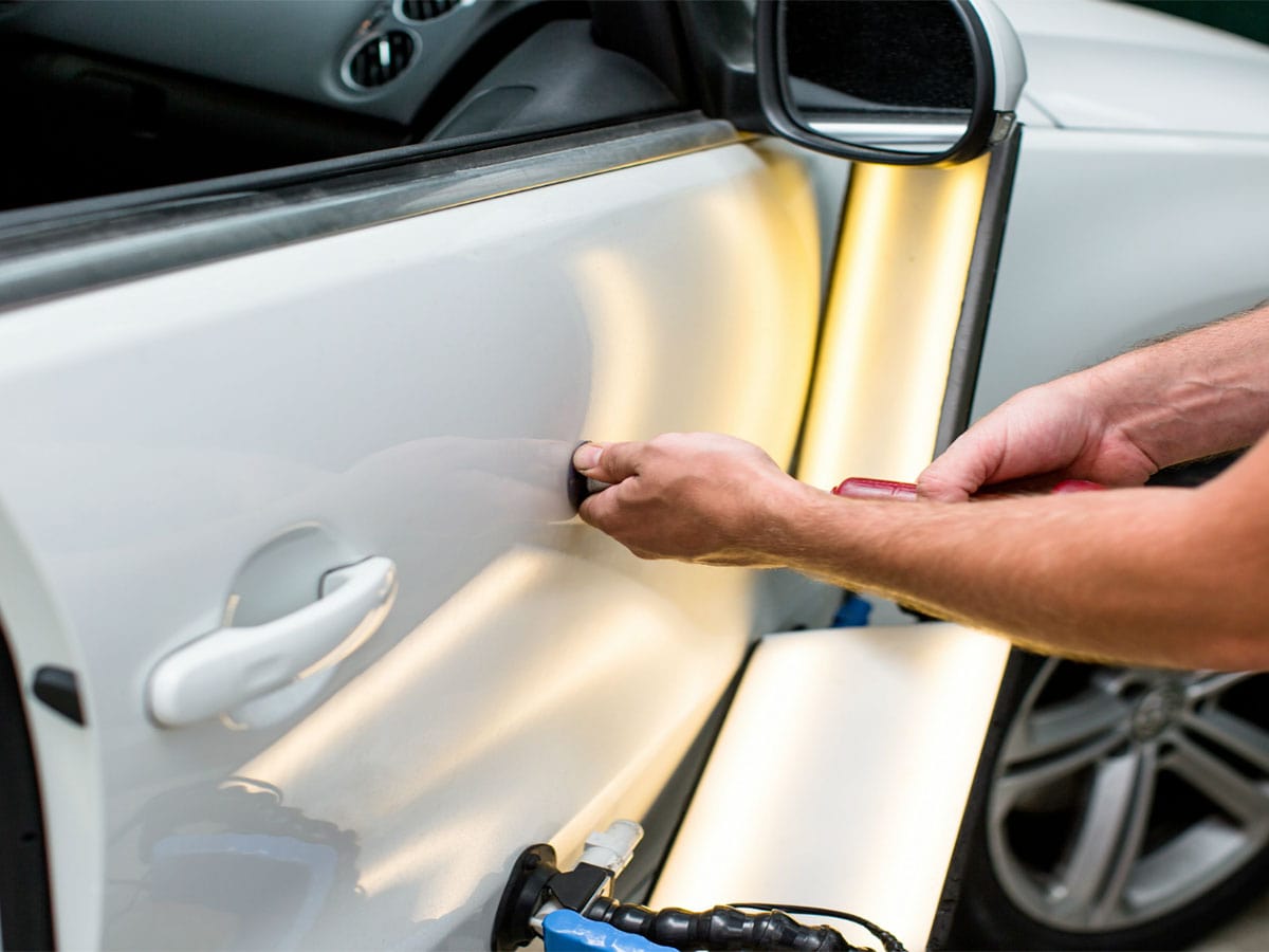 Foxfield auto hail repair of car door panel using PDR technique.